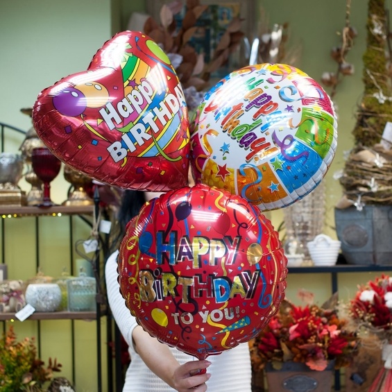 Three "Happy birthday" foil balloons